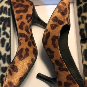 Animal print suede pumps .